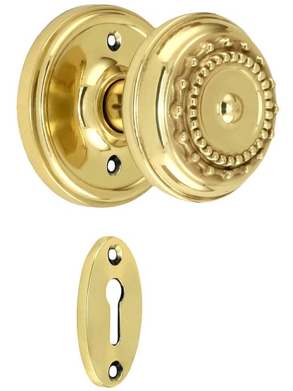 Classic Rosette Mortise Lock Set With Meadows Design Knobs in Polished Brass finish.